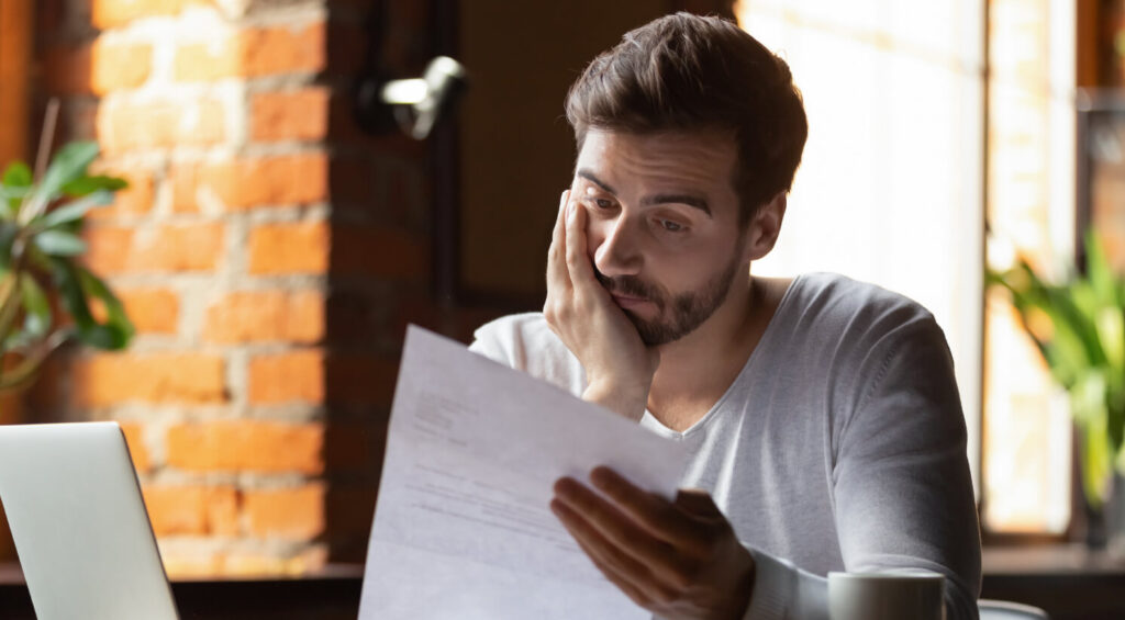 man reading about his insurance premiums going up